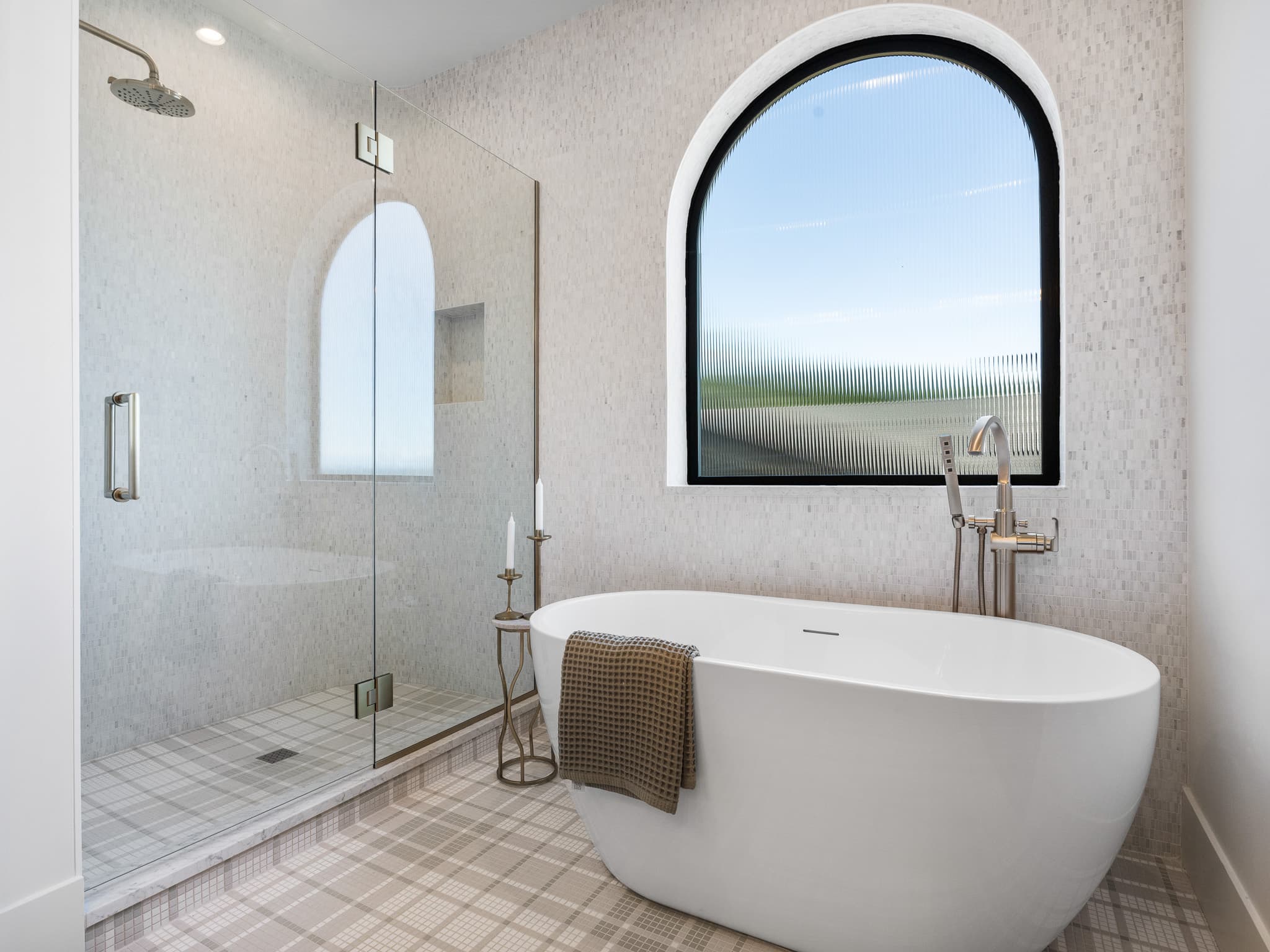 Modern primary bathroom remodel with a freestanding tub and custom tile by Portland Tile in Portland, OR