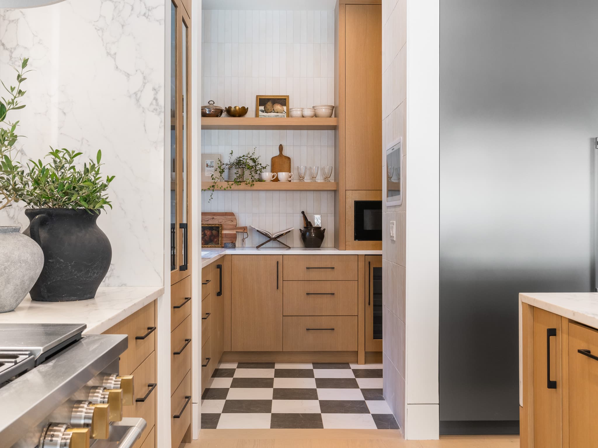Walk in pantry and scullery with white oak cabinetry and a checkerboard tile floor by Portland Tile in Portland, OR