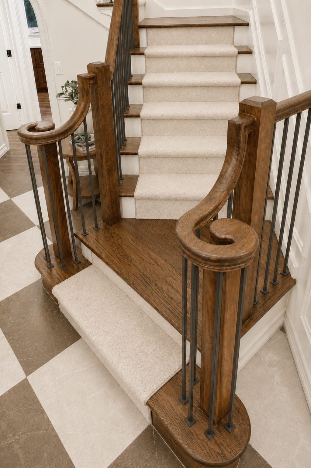 Staircase railing detail with a spiral handrail, black metal spindles, squared posts, and solid hardwood treads in Beaverton, OR