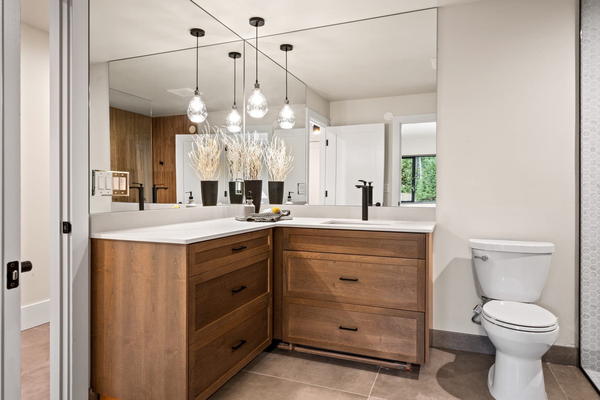 Corner vanity with black fixtures, quartz counter, and pendant lighting in Government Camp, OR